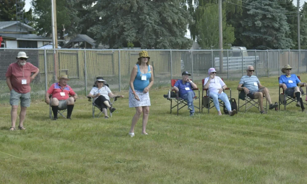Alberta Rvers Sitting In Lawn Chairs Watching Bocce Players